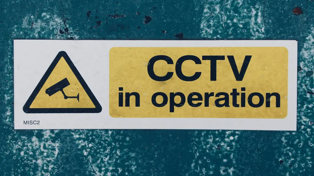 A yellow “CCTV in operation” warning sign on a wall