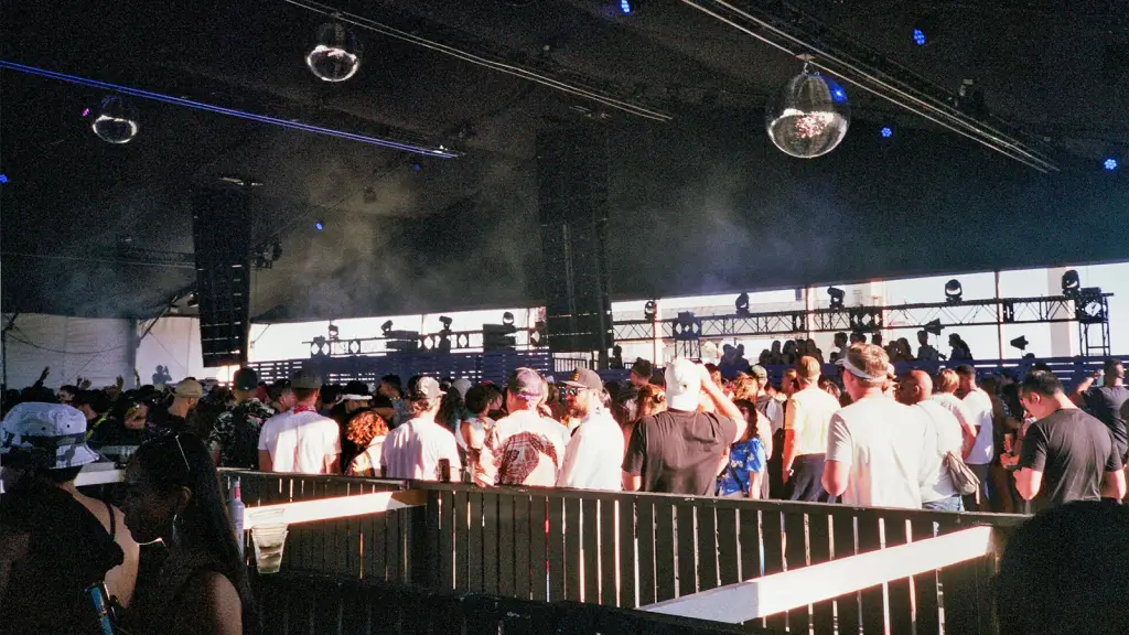 A large crowd at a live music venue facing a lit stage