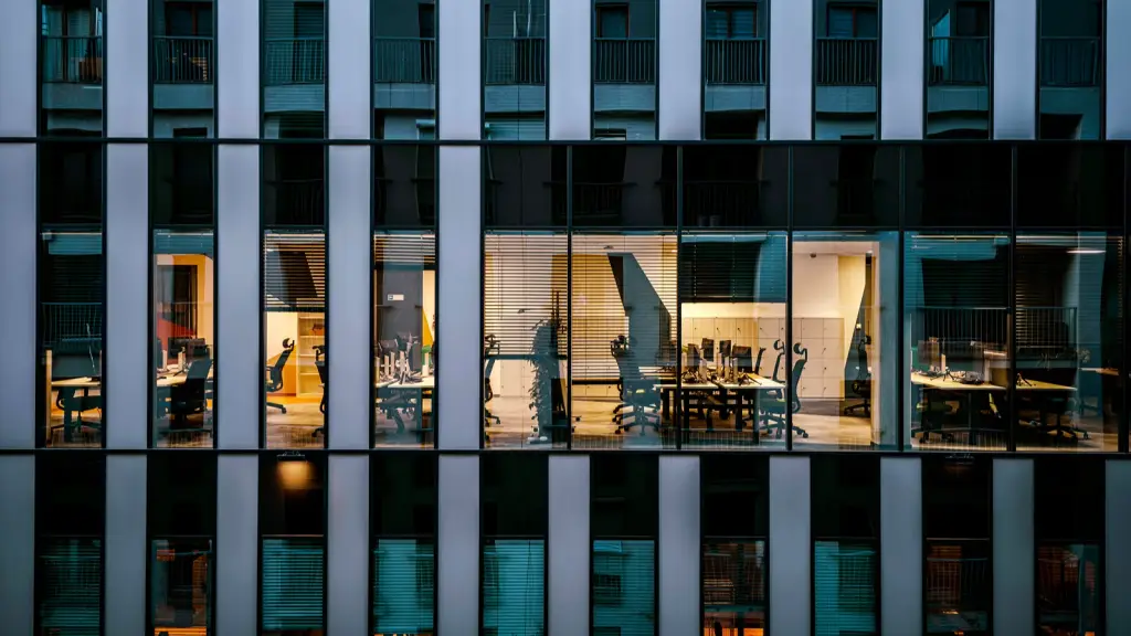 The lit facade of a modern office building at night